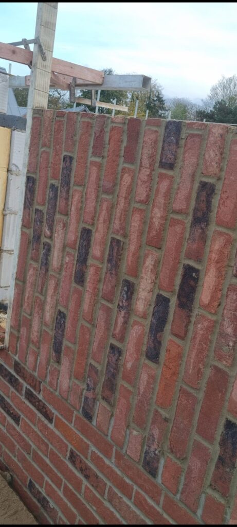Newly laid brick wall under construction, showcasing a unique